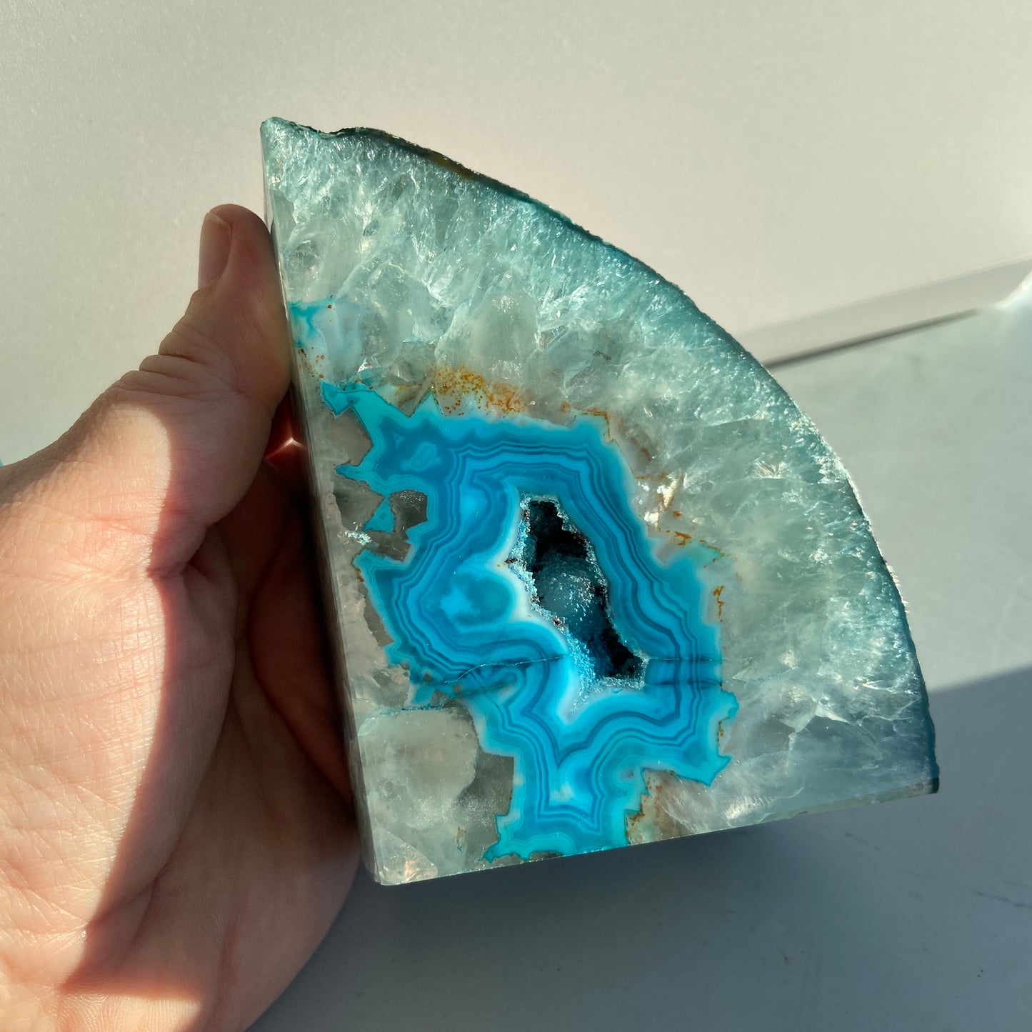 Blue agate geode bookend with sparkling crystal interior for home decor.