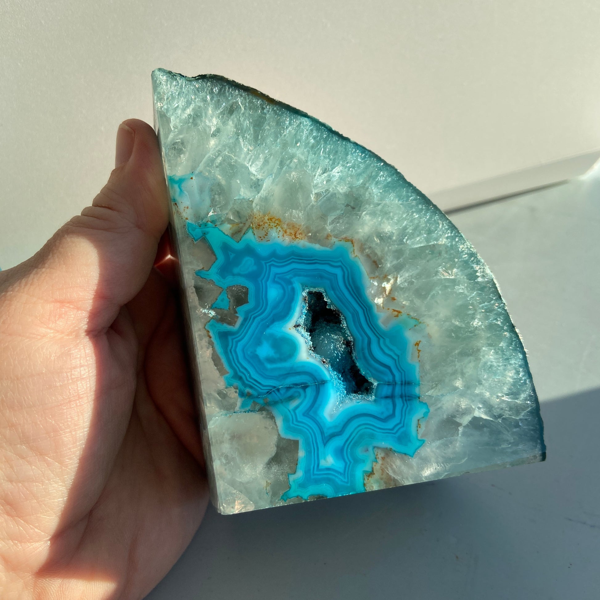 Blue agate geode bookend with sparkling crystal interior for home decor.