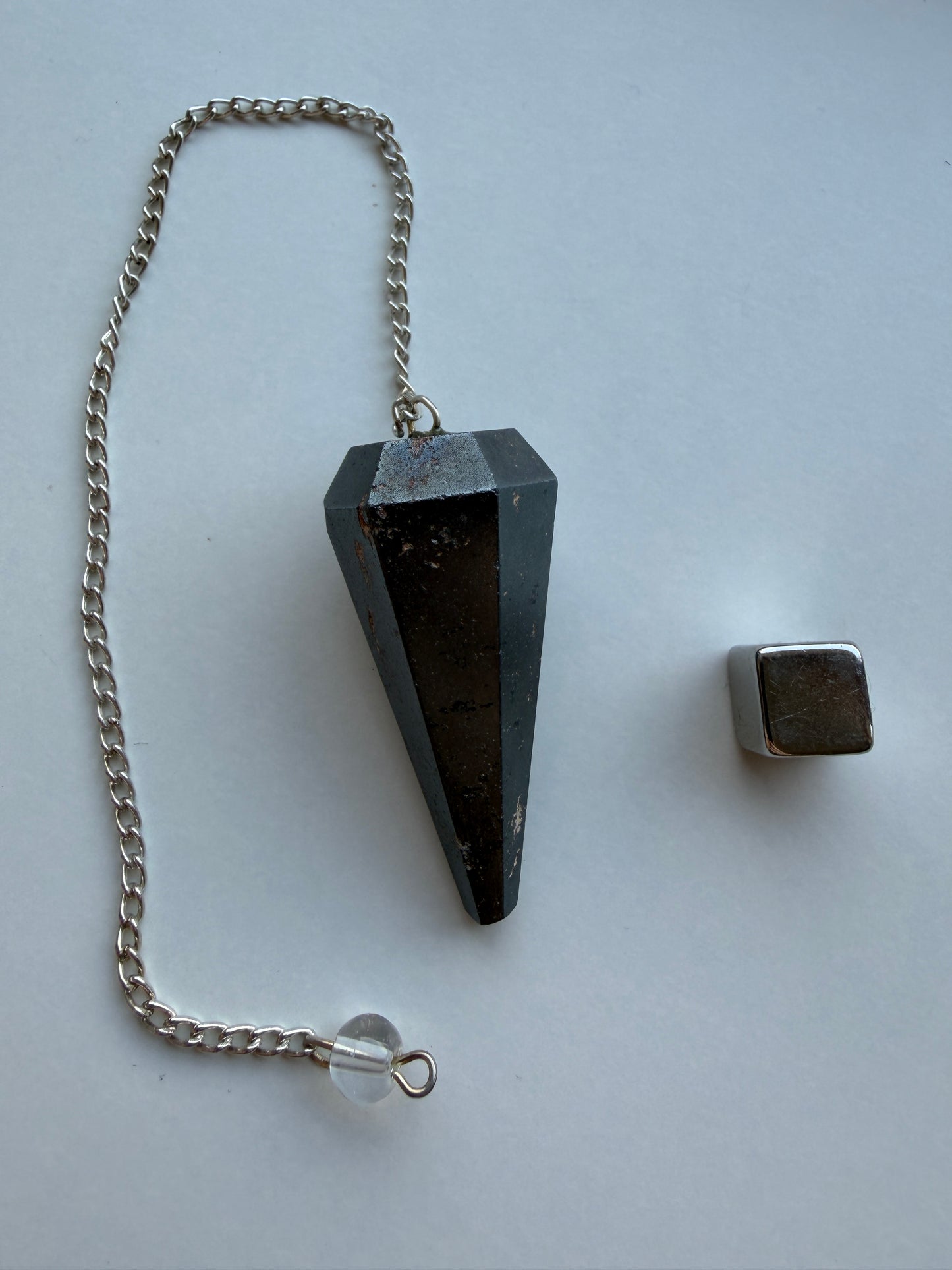Hæmatit pendul i mørk krystal med stærk grounding og beskyttende energi til pendularbejde.