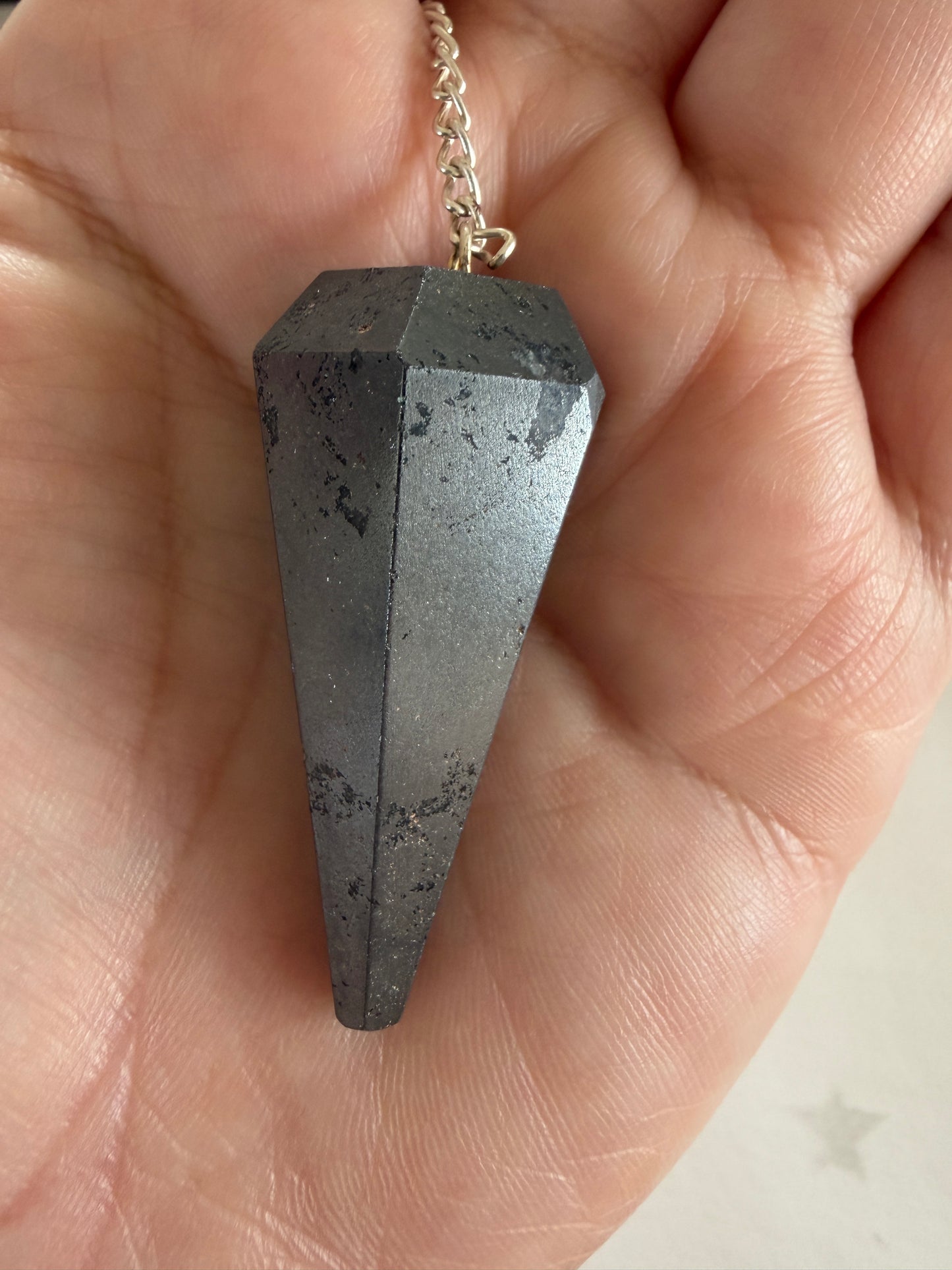 Hematite pendulum crystal used for grounding, protection and spiritual energy work.